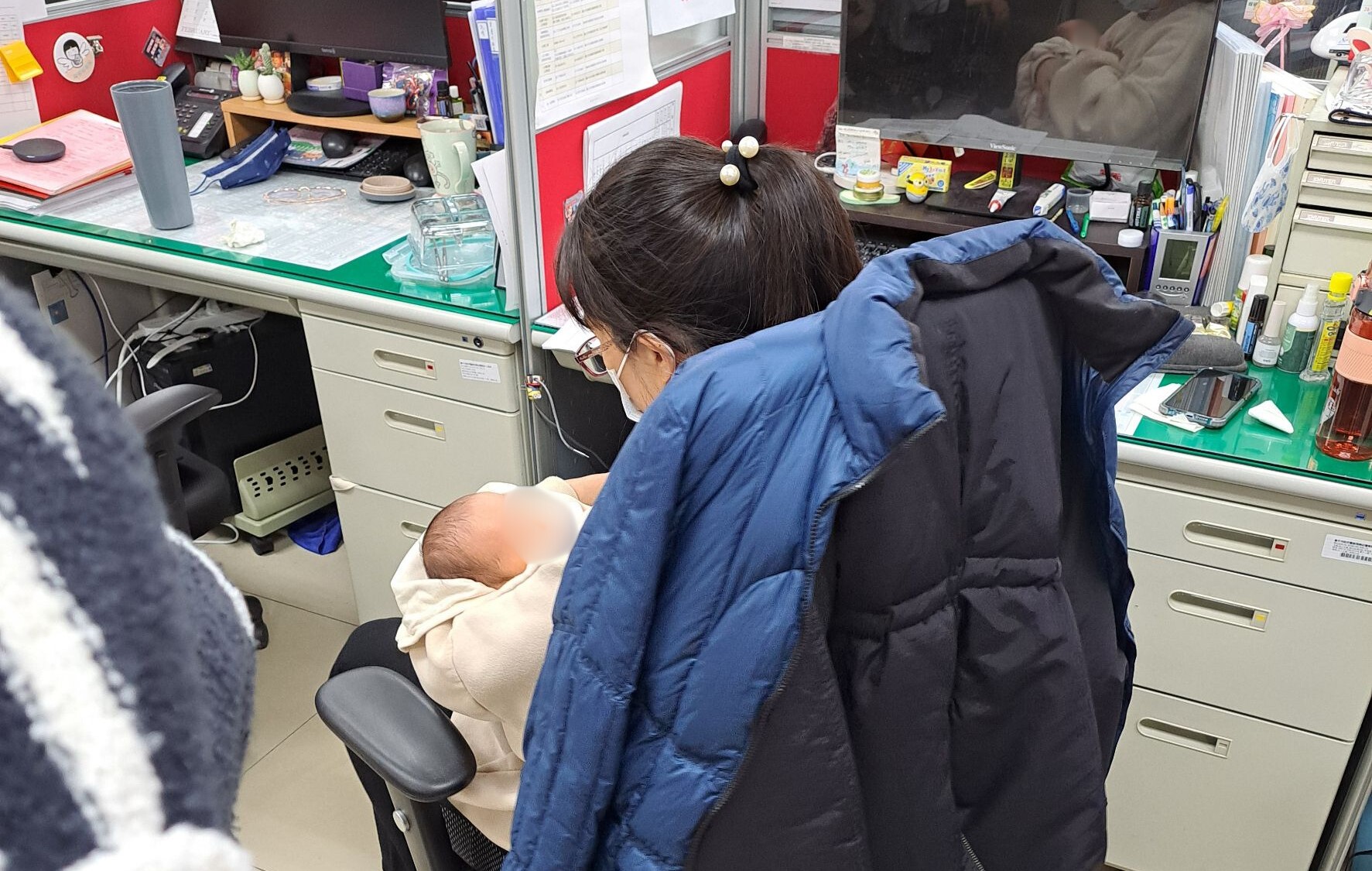 原本飢腸轆轆的嬰兒在喝完奶後露出心滿意足的表情，在警員曾英綾輕柔的搖晃中安穩入睡。