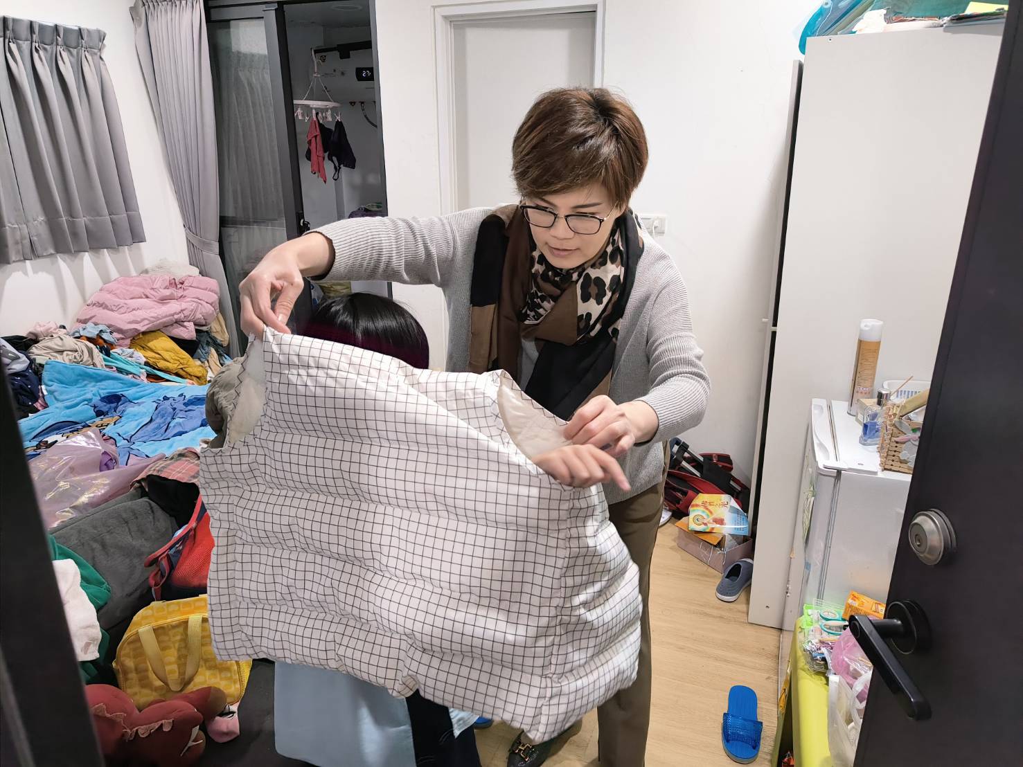 警員張雅雁協助李小妹試穿衣物是否合身